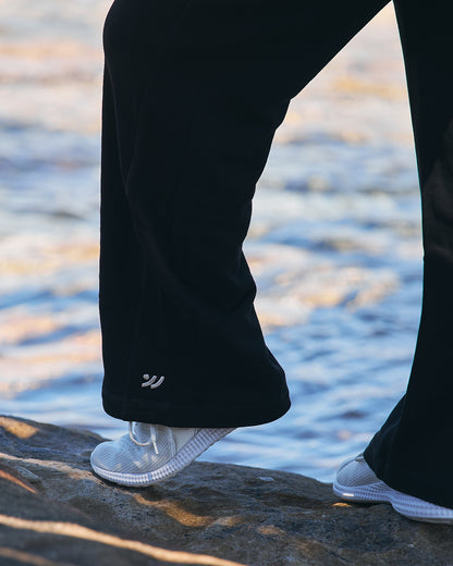 Moments Cozy Hoodie and Straight Leg Joggers in black, full-length shot under a wooden pier