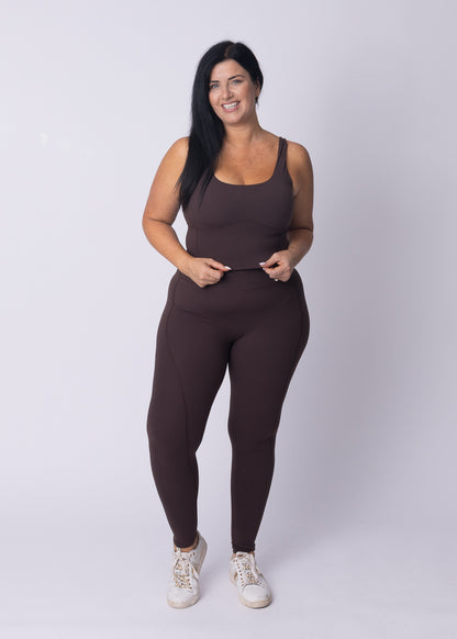 Moments Longline Sports Bra and High Waisted Leggings in coffee bean, full-body shot under a wooden pier
Side profile of Moments Workout Set in coffee bean, showing the longline bra cut and high waist legging fit