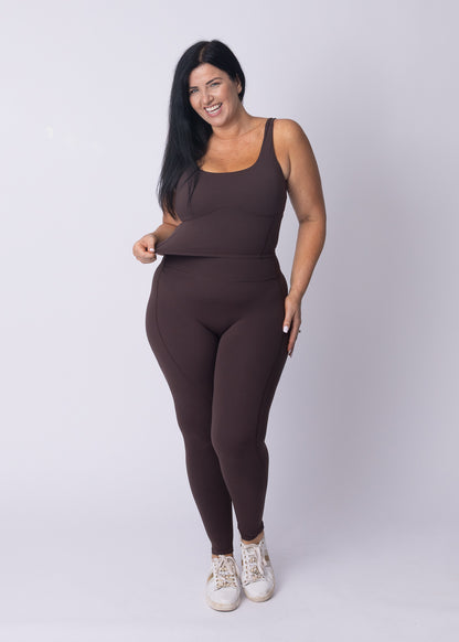 Moments Longline Sports Bra and High Waisted Leggings in coffee bean, full-body shot under a wooden pier
Side profile of Moments Workout Set in coffee bean, showing the longline bra cut and high waist legging fit