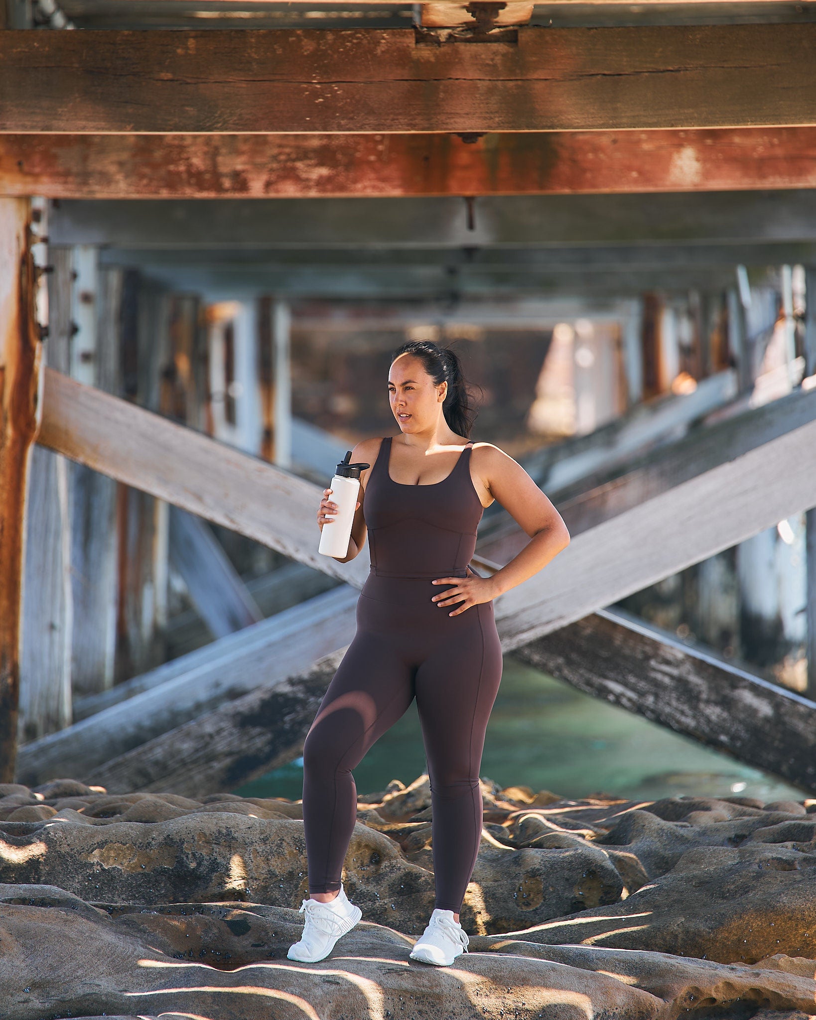 Woman wearing Womene Moments High Waisted Leggings in Coffee Brown — Australian activewear